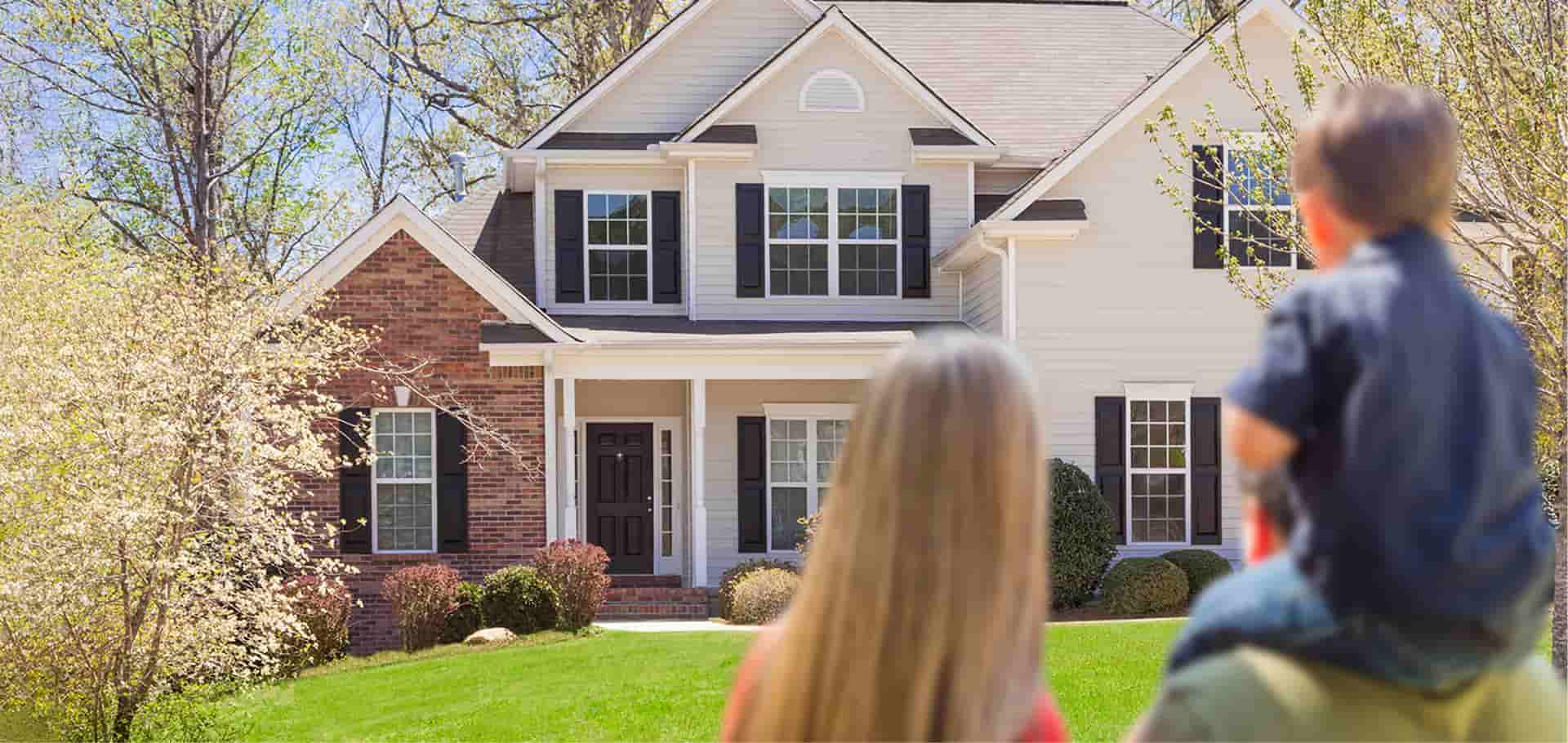 Family in front of new house
